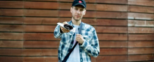 A man delivers papers to the person holding the camera.